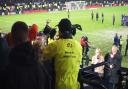 The fan is led away by stewards