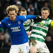 Todd Cantwell holds off a challenge from Celtic captain Callum McGregor